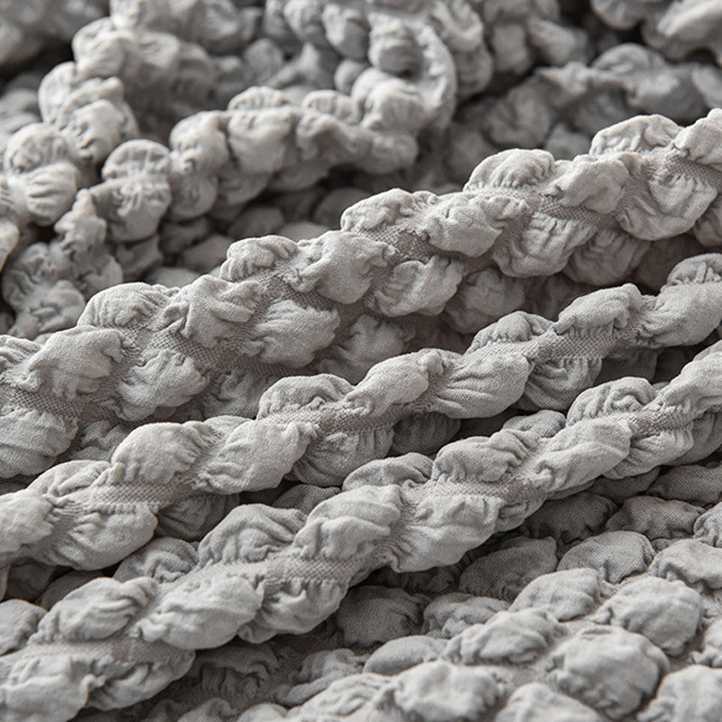 Sofaüberzug mit elastischen Rüschen und Noppenstruktur