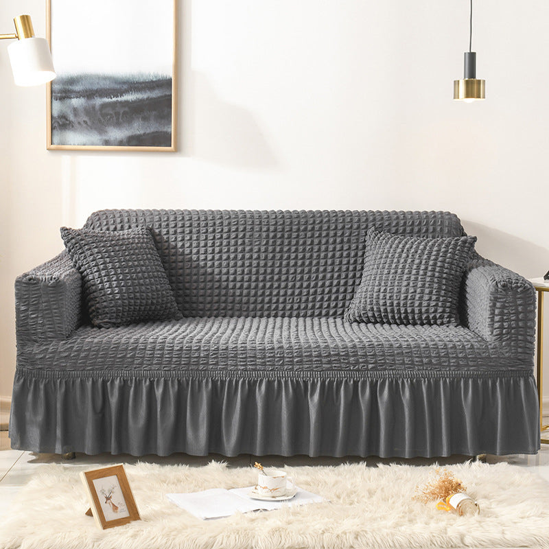 Sofaüberzug mit elastischen Rüschen und Noppenstruktur